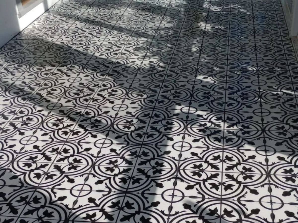 Black and white patterned tile floor laid across a bright room